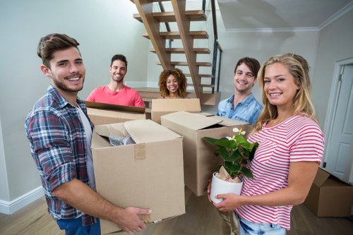 Removal team loading household items into a moving truck