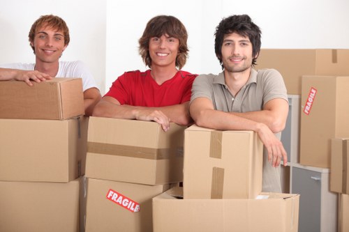 Movers preparing household furniture for transport in Goldersgreen