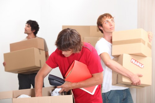 Professional movers handling office assets during a commercial move in Goldersgreen